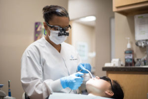 Dental Hygienist performing a routine dental cleaning