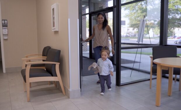toddler girl and mother walking into a first dental appointment at Virginia Family Dentistry's Pediatric Office
