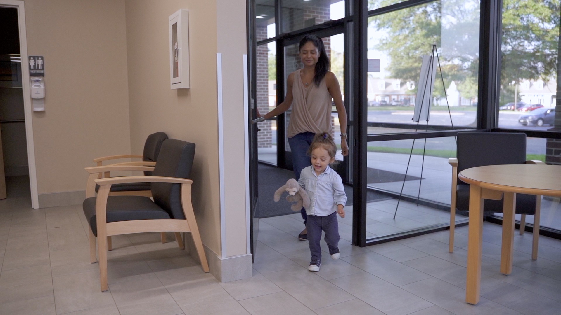 toddler girl and mother walking into a first dental appointment at Virginia Family Dentistry's Pediatric Office